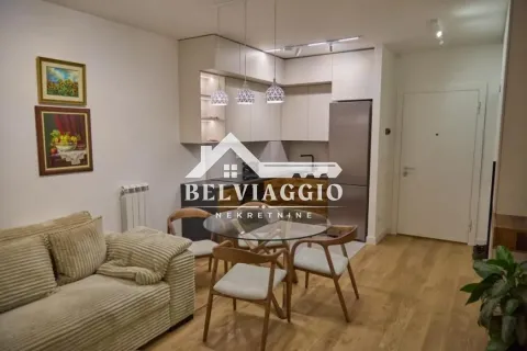 Living room with dining area and fitted kitchen in the background. - image 2