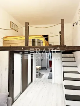 Modern loft bedroom with a bed and staircase. - image 8