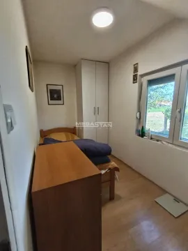 Small bedroom with a bed, wardrobe, and a window. - image 11