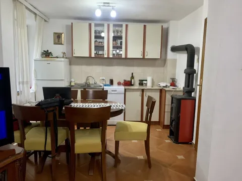 A kitchen with a dining table and a wood-burning stove. - image 10