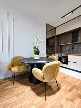 Kitchen with a dining table and yellow chairs. - image 7