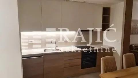 Modern kitchen with built-in units and a dining table. - image 6