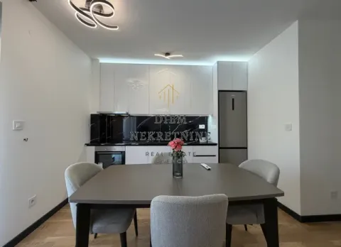 Modern kitchen with a dining table and chairs. - image 6