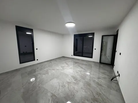 Empty room with ceramic tiles and black window frames. - image 13