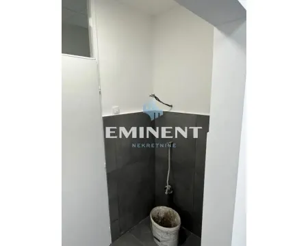 Bathroom under renovation with dark tiles on the lower part of the wall. - image 11
