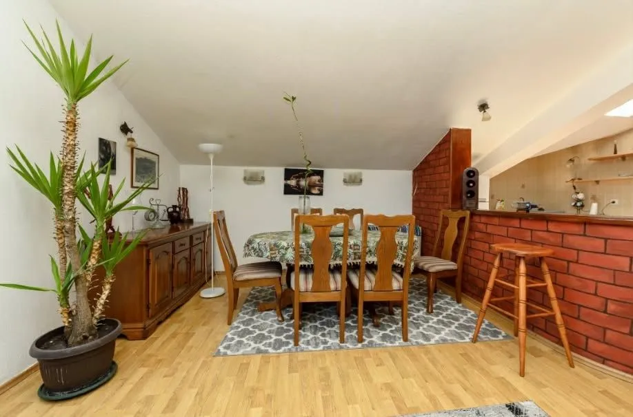 Living room with dining area and wooden furniture.