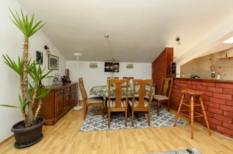 Living room with dining area and wooden furniture. - image 7