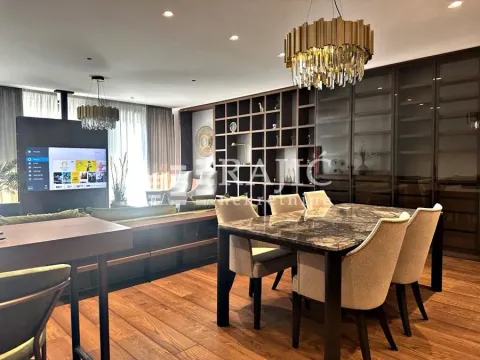 Modern living room with dining area and built-in wardrobes. - image 2