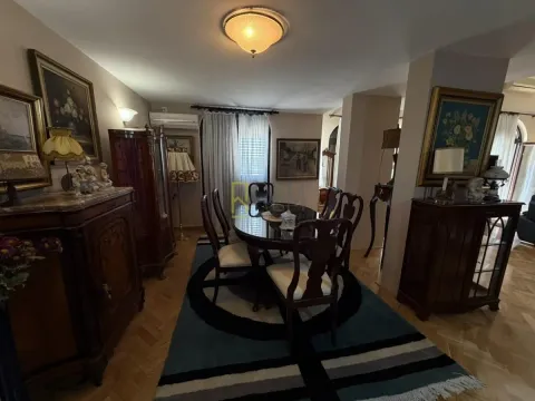 Living room with a dining area and classic furniture. - image 4