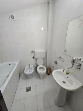 Bright equipped bathroom with a bathtub, washbasin, and sanitary fixtures. - image 5