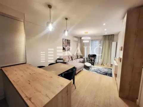 Living room with dining area and kitchen counter in a modern apartment. - image 3