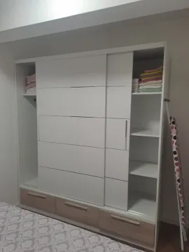 Large white wardrobe with shelves and drawers in the bedroom. - image 7