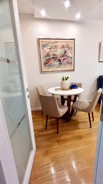 Trpezarija sa okruglim stolom, četiri stolice i umjetničkom slikom na zidu. - image 4