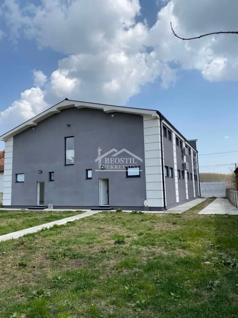 Exterior view of the building with a yard.