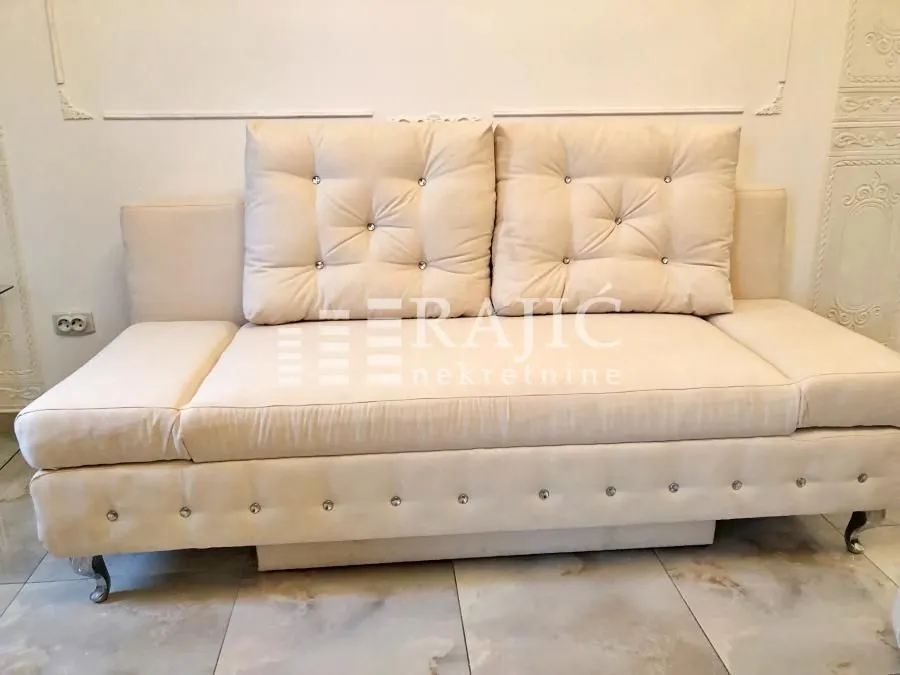 Beige sofa with cushions in the living room.
