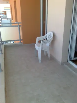 Terasa sa popločanim podom i složenim plastičnim stolicama. - image 11