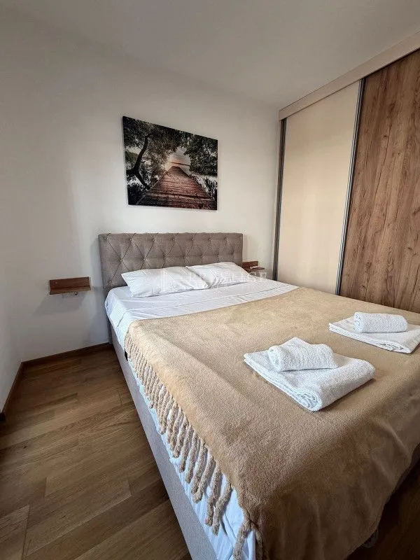 Furnished bedroom with a double bed and built-in wardrobe.