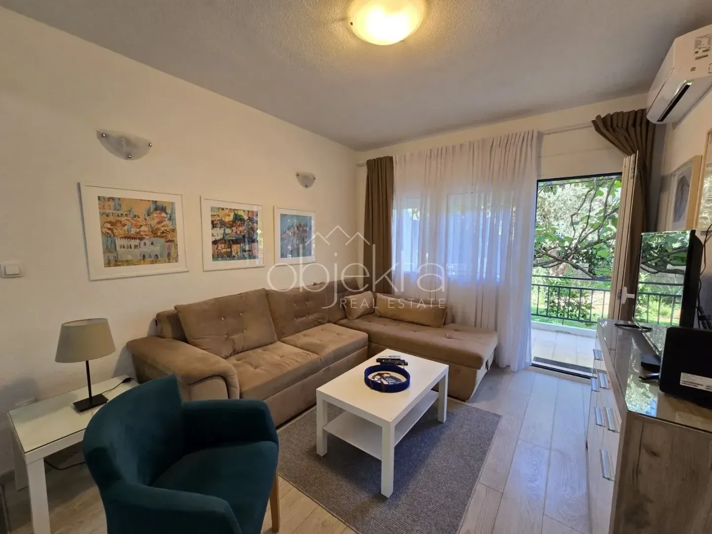 Living room with a sofa, coffee table, and access to the terrace.