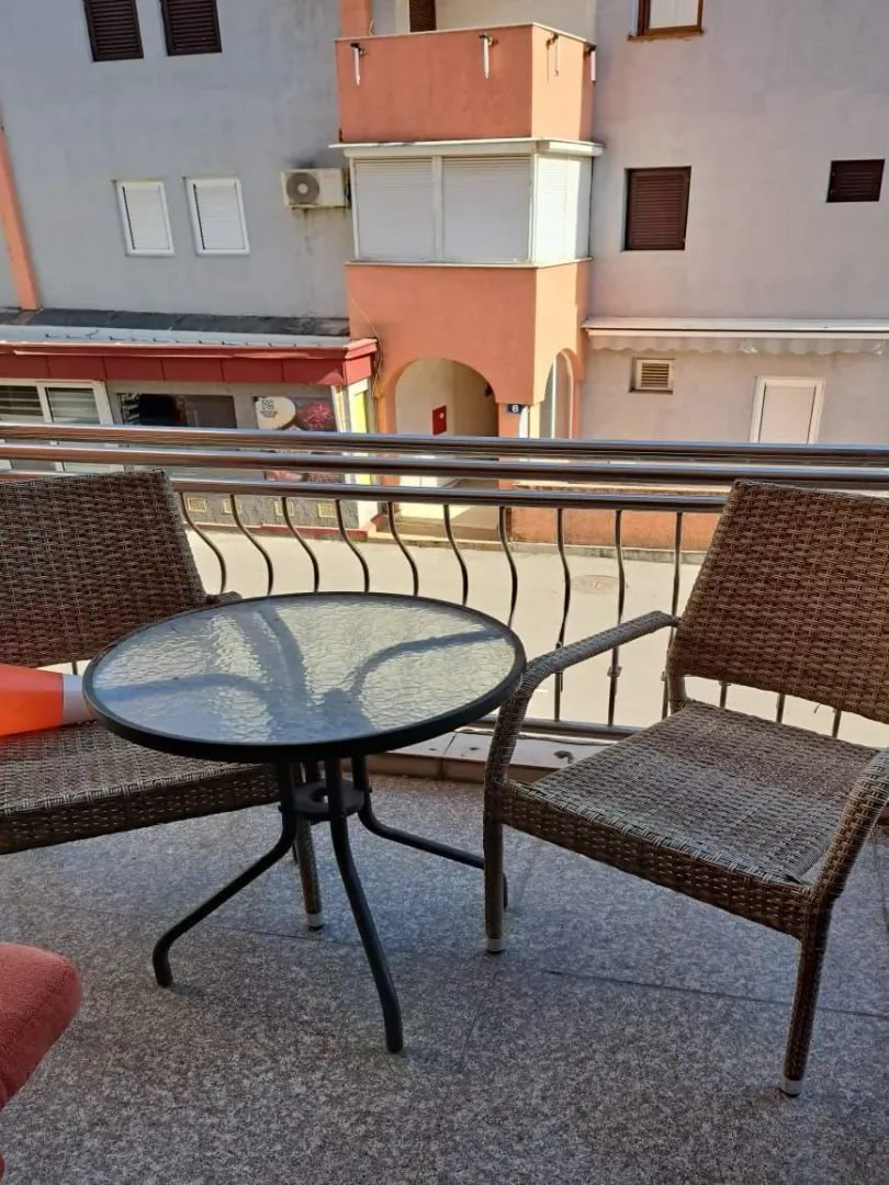 Furnished balcony with a table and two chairs.