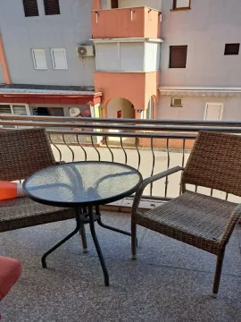Furnished balcony with a table and two chairs. - image 24