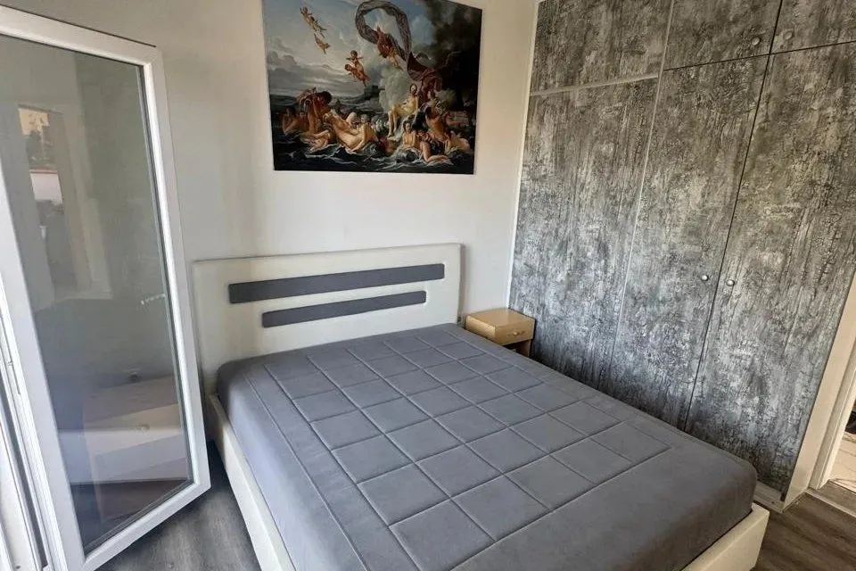 Furnished bedroom with a double bed and built-in wardrobe.