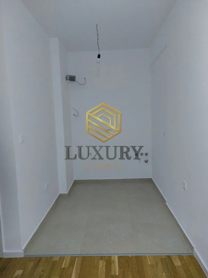 Empty room with white walls and tiled flooring.