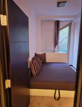 Small bedroom with a bed and access to the terrace. - image 8