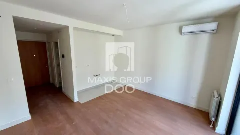 Empty living room with wooden flooring, air conditioning unit and kitchen connections. - image 4