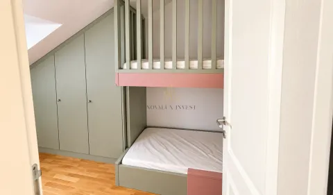 Children's bedroom with bunk beds and a built-in wardrobe under the slanted ceiling. - image 12