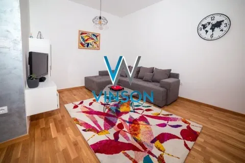 Living room with a sectional sofa, coffee table and television. - image 2
