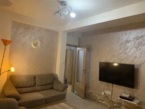 A living room with a comfortable sofa, wall-mounted TV, and decorative lighting. - image 3