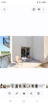 Furnished terrace with a table and chairs in front of the apartment entrance. - image 14