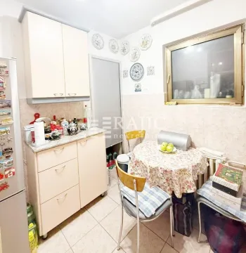 Small kitchen with a dining table and kitchen cabinets. - image 8