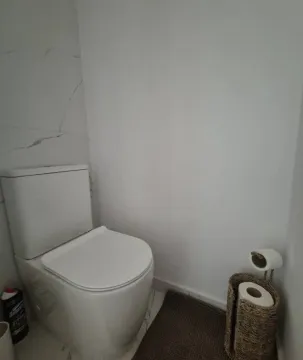 View of a modern bathroom equipped with a toilet. - image 2