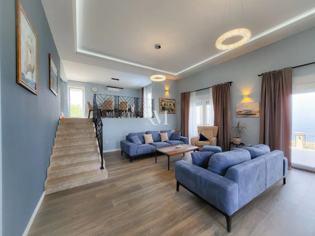 Spacious living room with a sofa set and stairs leading to the upper level.