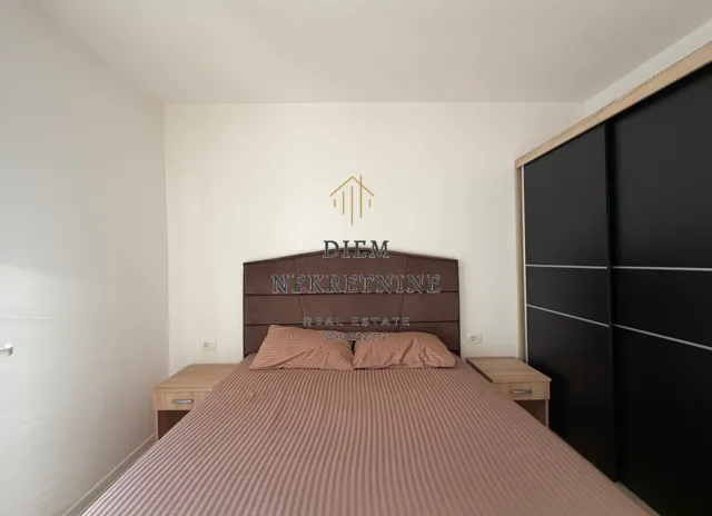 Bedroom with a double bed, bedside tables and a wardrobe.