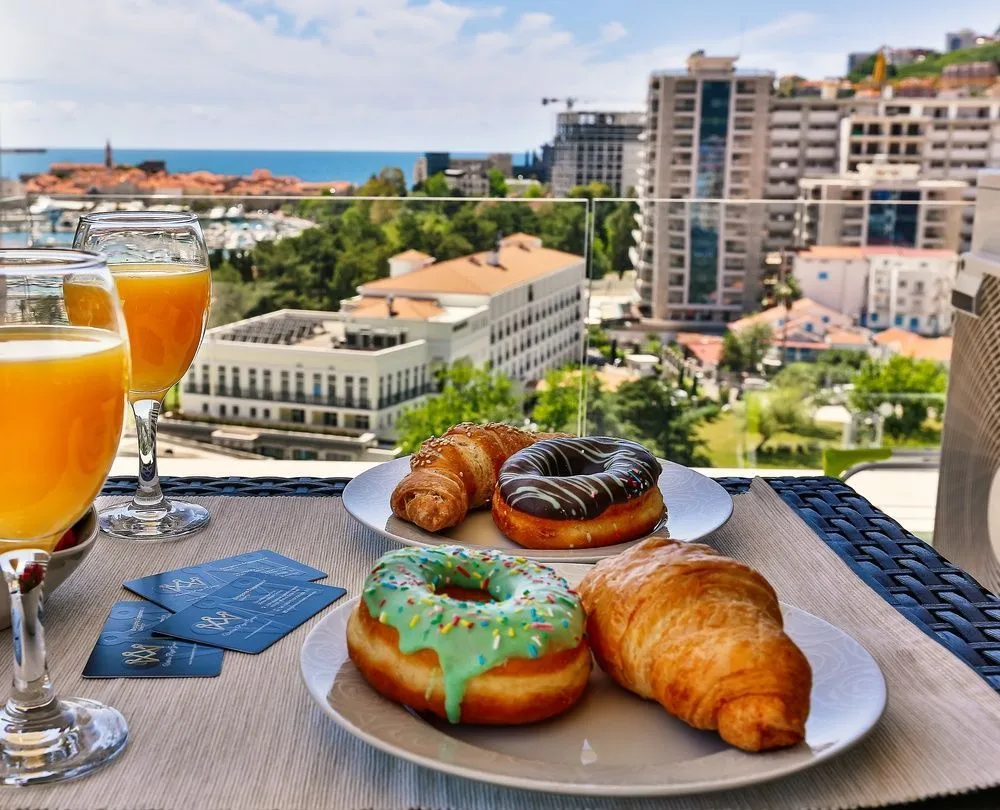 Breakfast table with a view of the city and sea from the terrace.