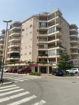 View of the facade and entrance of an apartment building with terraces. - image 2