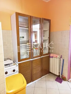 Smaller kitchen with wooden units and a stove. - image 9