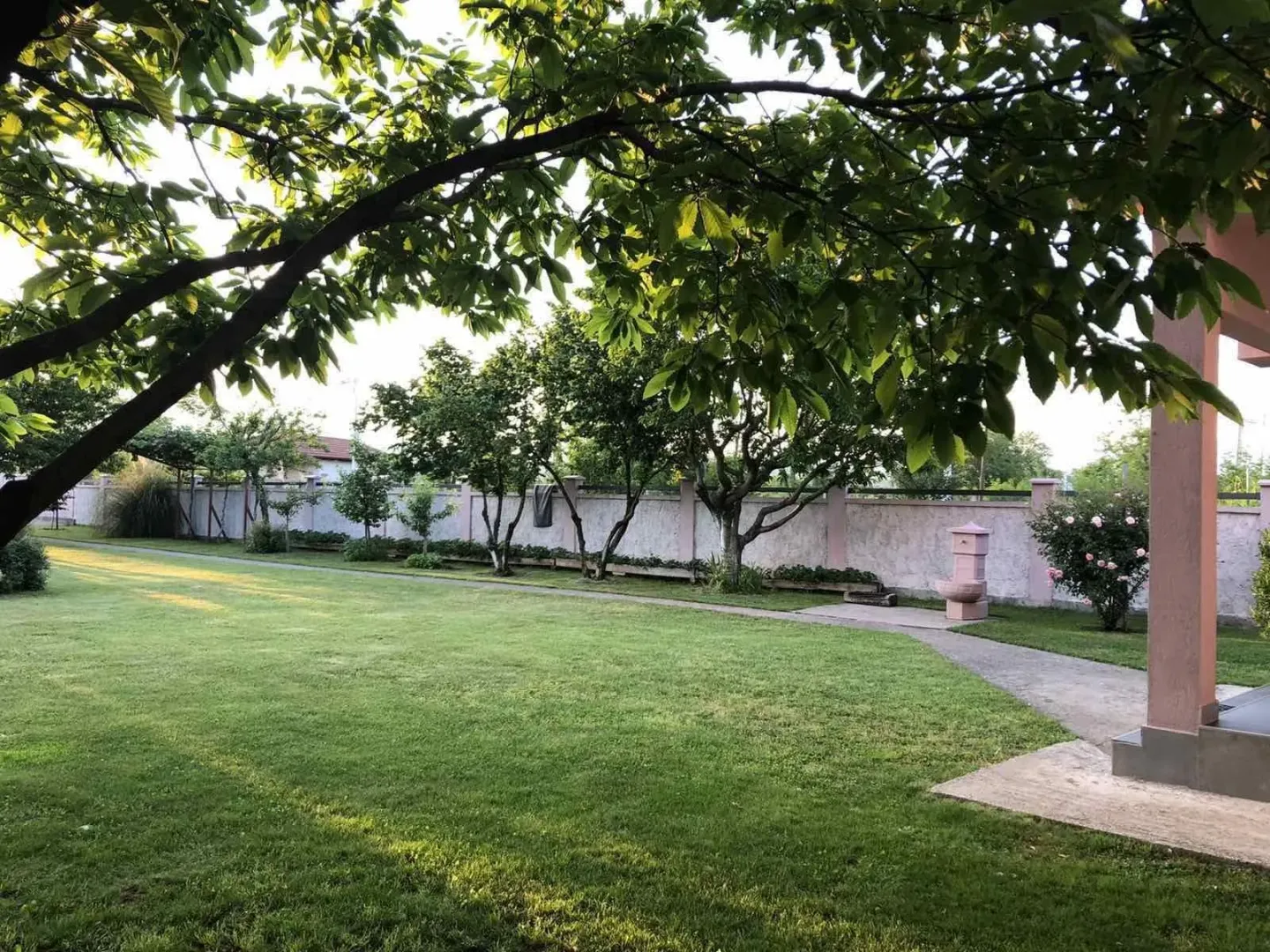 A spacious and beautifully landscaped yard with a green lawn.