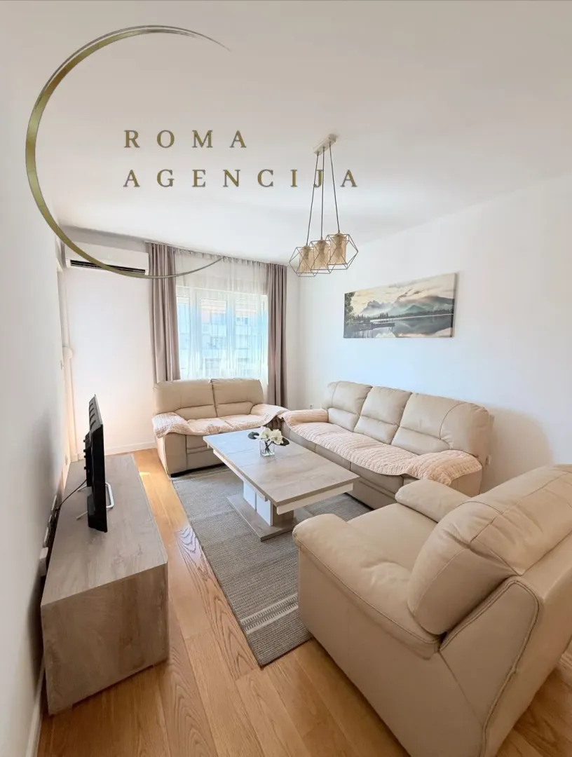 Living room with sofa set, coffee table, and TV.