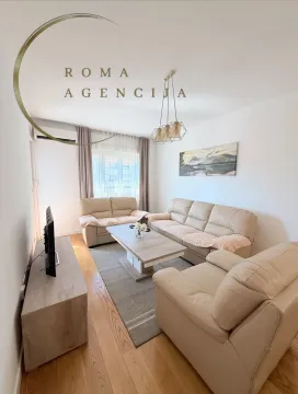 Living room with sofa set, coffee table, and TV. - image 3