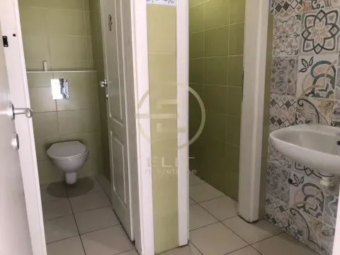 View of the bathroom with a washbasin and toilet. - image 10