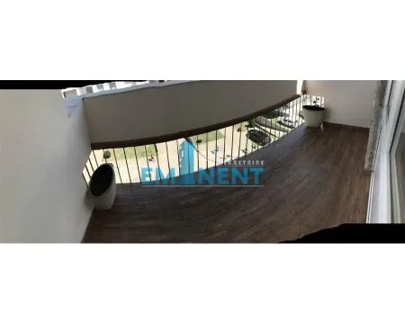 Spacious balcony with wooden flooring and a view of the surroundings. - image 14