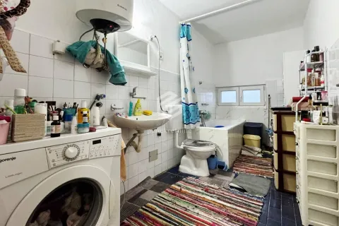 Manje opremljeno kupatilo sa kadom, umivaonikom i veš mašinom. - image 6