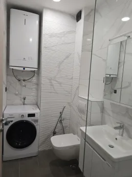 Savremeno opremljeno kupatilo sa tuš kabinom, umivaonikom, toaletom i veš mašinom. - image 15