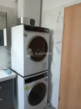 Bathroom with a washer-dryer unit and a water heater. - image 12