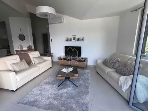 Living room with sofas, a TV, and access to the terrace. - image 8