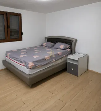 Furnished bedroom with a double bed and a bedside table. - image 6