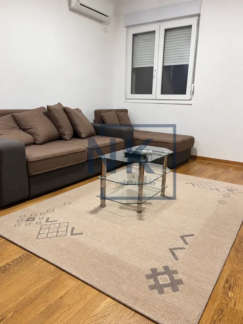 Living room with a corner sofa, coffee table, and rug.